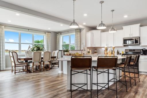 (*Photo of decorated model, actual homes colors and finishes will vary) Modern and functional, the kitchen is sure to impress. This spacious room includes Quartz countertops, stainless appliances, a gas cooktop and, a spacious morning room