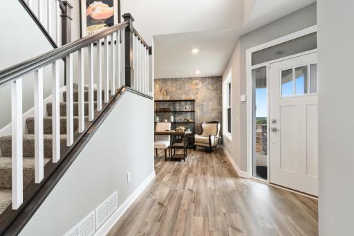 (*Photo of decorated model, actual homes colors and finishes will vary) First impressions matter and this home features sophistication at the front door.