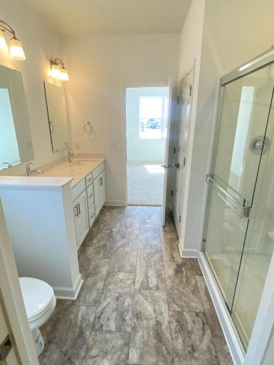 (Photo of actual home) Owner's ensuite bath, with double-sink vanity and large shower. Photos of actual home as of 3/29!