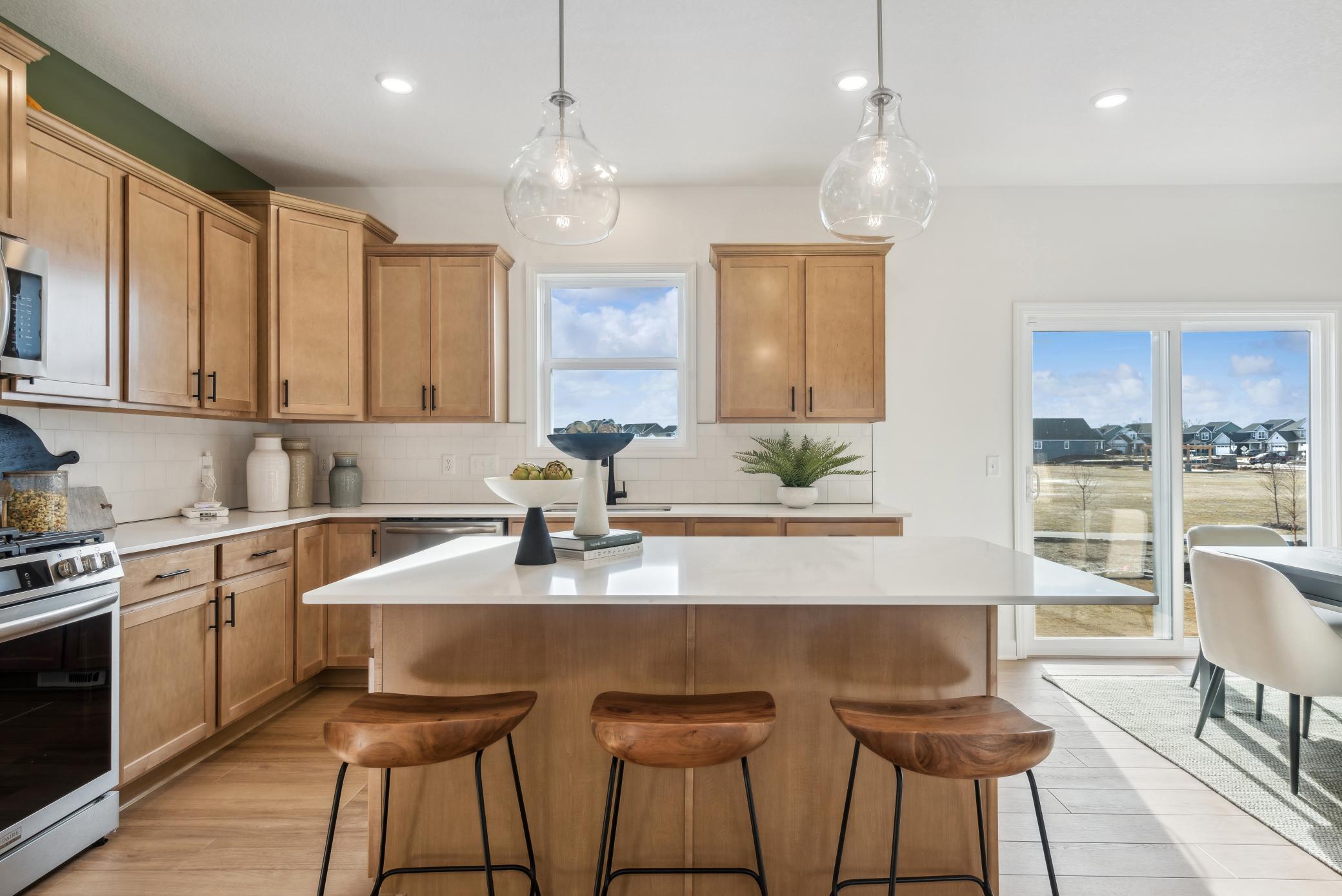 (Photo of model home, actual features may vary) The kitchen island can be turned into an informal dining area, with plenty of space for bar stools or high top chairs