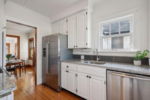 Bright kitchen with Bosch stainless steel appliances and granite countertops.