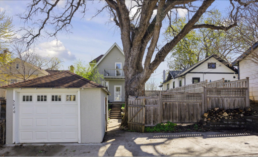 Detached garage with gated door into privacy fence with additional off-street parking.