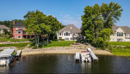 This property has a gorgeous flat backyard leading to 103ft. of lakeshore with sandy beach.