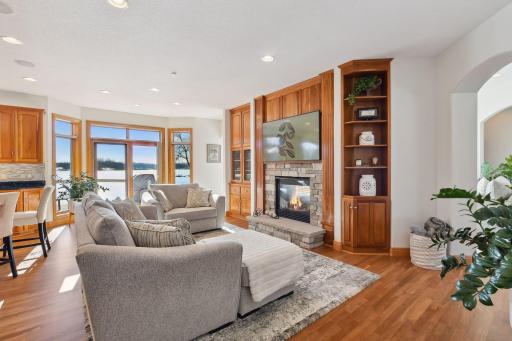Cozy hearth room with see-through gas fireplace and updated stone surround.