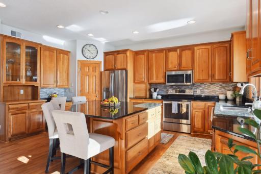 Complete with spacious center island, walk-in pantry, as well as ample cabinets and counter space.