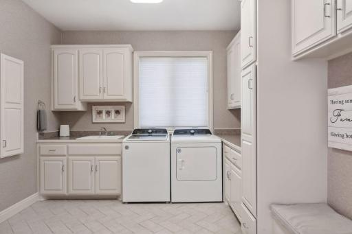 Oversized back entry room complete with laundry, built-in ironing board, space for folding, storage, as well as a walk-in closet.