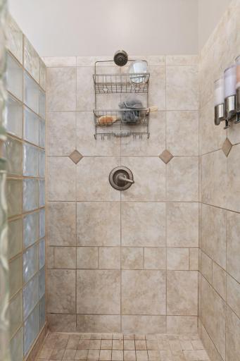 Full walk-in ceramic and glass block shower with curb.