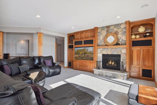 Large, open family room with surround sound, gas fireplace and plush new carpet.