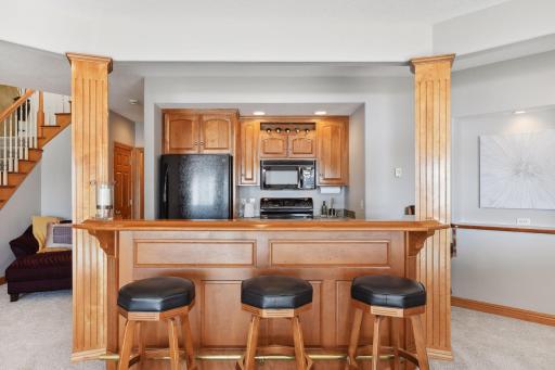 Custom cherry wood bar with matching barstools.