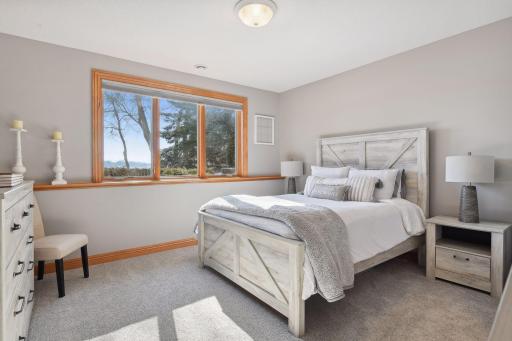Lower-level bedroom on the south side of the home also includes a 65" TV.