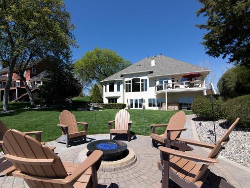 Custom recessed paver lights will guide you at night down to a lakeside fire pit overlooking the lake.