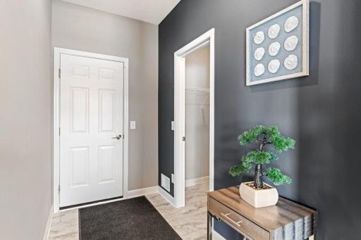 (Photo is of a model, homes finishes will vary) The mudroom located on the main floor with a spacious closet!