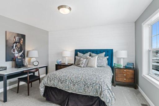 (Photo is of a model, homes finishes will vary) One of three spacious secondary bedrooms.