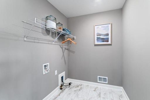 (Photo is of a model, homes finishes will vary) Laundry located on the upper level!
