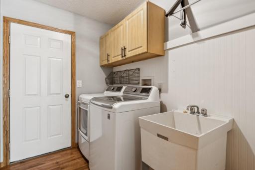 Main floor laundry with cabinets and laundry tub ...washer and dryer are included.