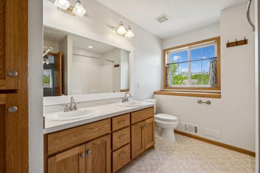 Upper level full bath with double vanity.