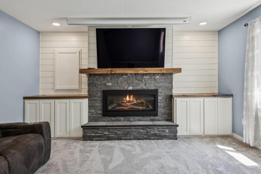 Close up of the gas fireplace and built ins in the lower level family room.
