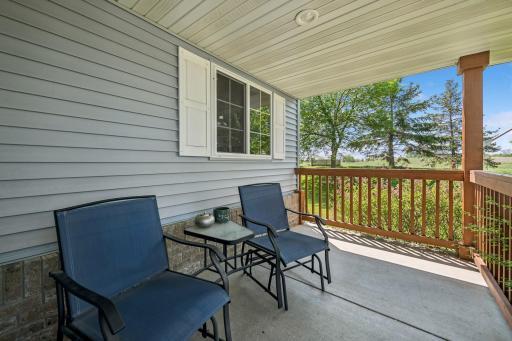 A nicely sized open front porch with seating area greets you at the front door.