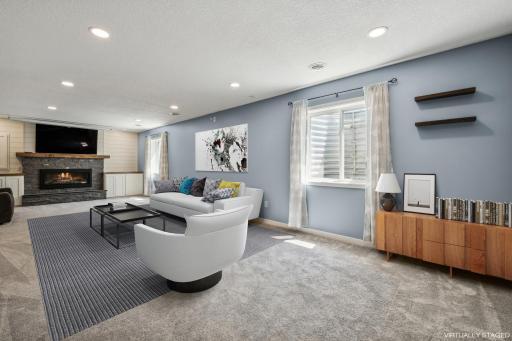 The lower level family room includes new carpeting, a gas fireplace (with walnut mantle) and built in cabinets with walnut tops.