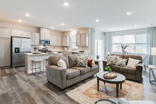 The Fairmont's open concept offers ample space on the main level. Large windows allow natural light to stream through, while the covered patio provides privacy and shade for your outdoor enjoyment. *Photo is of model home.