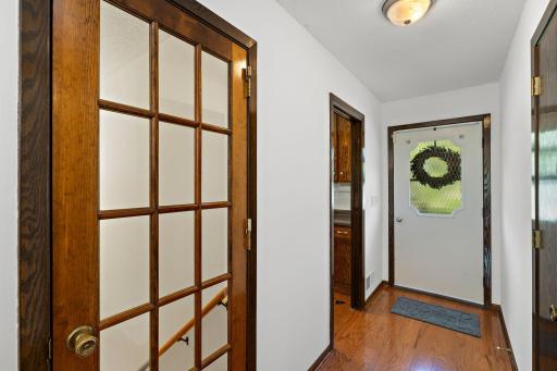 Convenient entry way with closet and French Door leading to lower level