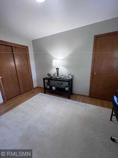 3rd bedroom with wood floor and two closets.