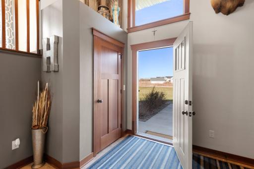 Dramatic 2-story entry into a spacious foyer with closet and access to the garage.