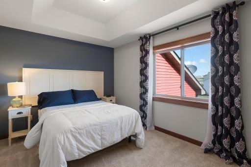 The primary bedroom features private bath, walk in closet, and tray ceiling.