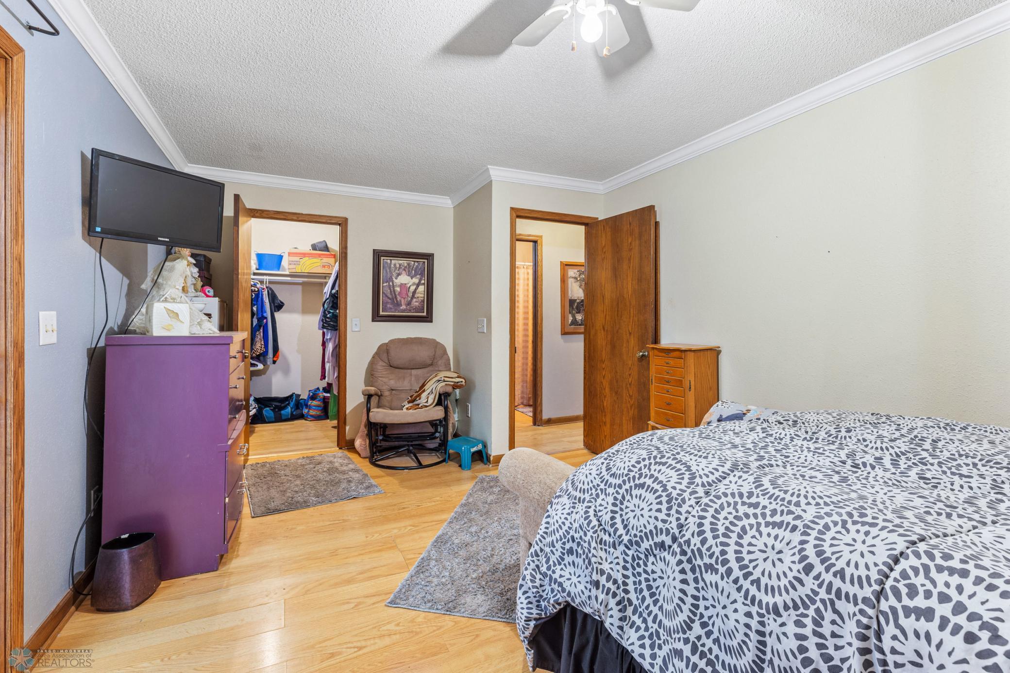 Main Floor Primary Bedroom; walk-in closet and patio door to back yard