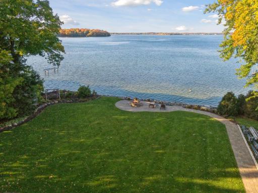 Manicured grounds lead the way to the lakeside patio delivering panoramic views across Lower Lake.