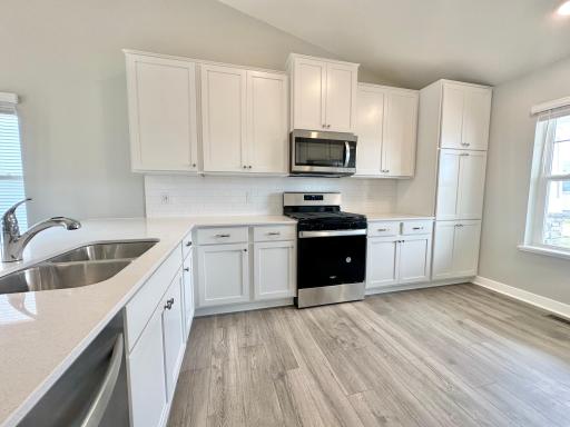 Welcome home to D.R. Horton's Rushmore showcasing our white designer package with quartz countertops and oversized subway tiled backsplash. *Photo of previous spec home.