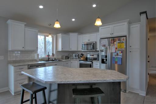 Perfect entertaining kitchen with SS appliances, large center island and modern new backsplash