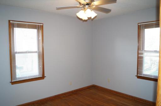 Main level bedroom, hardwood floors throughout the property