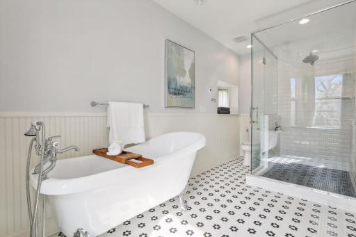 A spa bath with custom heated tile floors and a beautiful soaking tub.