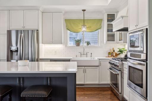 This whole home renovation includes a gourmet open concept kitchen complete with commercial grade appliance, quartz counters, a center island, custom cabinetry and lighting.