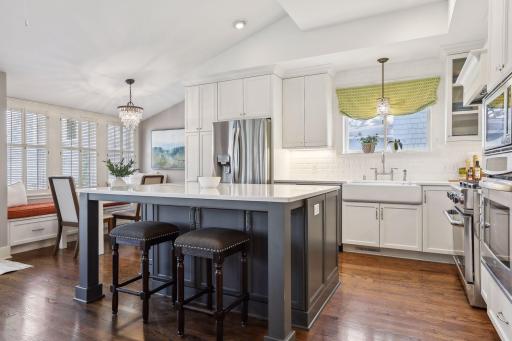 An oversized custom designed island with a quartz counter is perfect for entertaining.