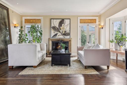 Beautifully renovations include this stunning main level living space centered by a stone surround fireplace, oversized windows, high ceilings and refinished chocolate oak floors.
