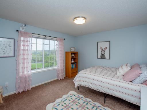 2nd of 3 bedrooms on upper level. It's pretty spacious! And it overlooks the pond and golf course.