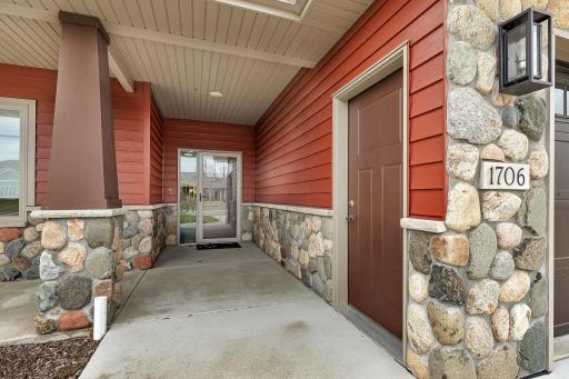 Steel siding and stonework greets you at the front door