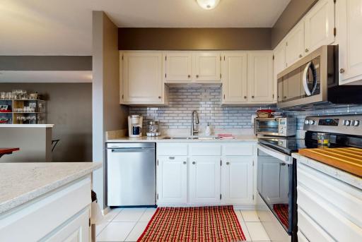 Modern updates to this adorable kitchen include- New tile flooring, backsplash, stainless steel appliances and beautiful granite counters.