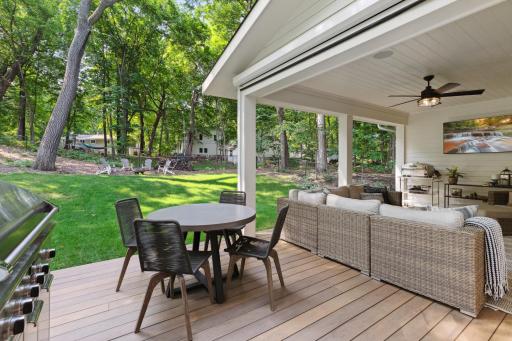 Inviting back porch features phantom screens that easily come down when desired