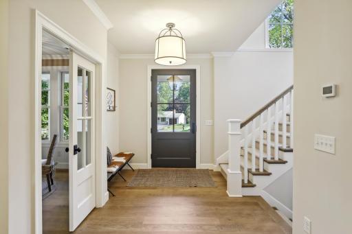 Spacious foyer showcasing an architecturally beautiful staircase