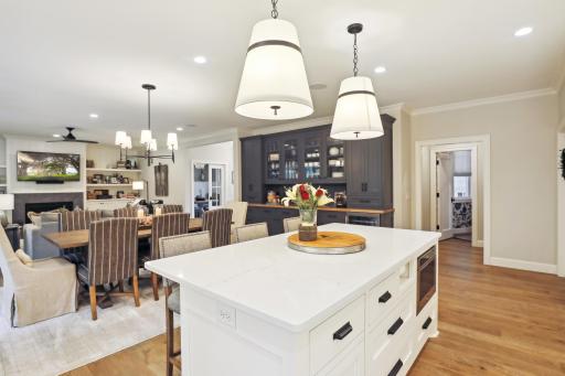 A beautiful built-in buffet offers a beverage fridge, a tremendous amount of storage and additional serving space