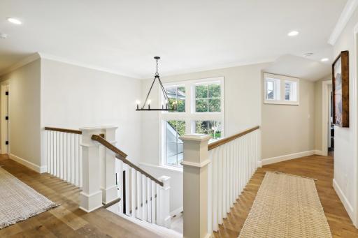 Natural light floods the open staircase to the upper level
