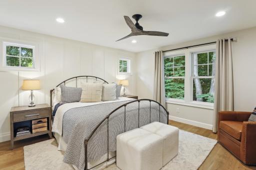 The primary suite offers hardwood flooring, walk-in closet and private bath
