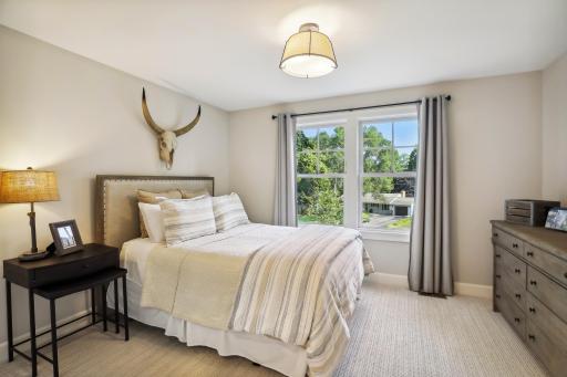 Bedroom 2 on upper level features a walk-in closet and private 3/4 bath