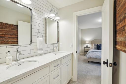 The walk-through hallway full bath offers great design and finish. Timeless subway tile backsplash and quartz counters.