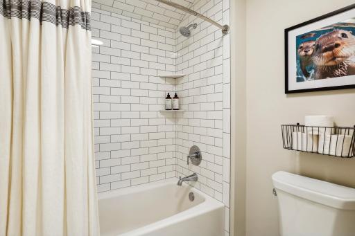 Subway tile is continued around the tub surround