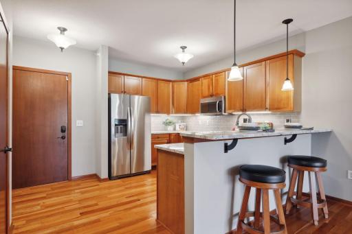 Welcome to Unit #213 - sun-filled second floor unit with balcony deck overlooking green spaces, mint-condition hardwood floors, granite tops and updated stainless appliances.