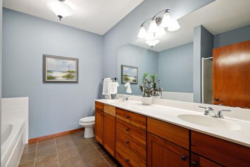 Owner's bathroom has dual sinks, separate tub and shower, tiled floors and updated fixtures.